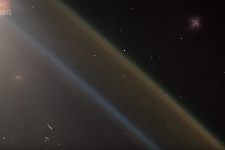 The ascending Soyuz rocket can be seen in the upper right-hand corner