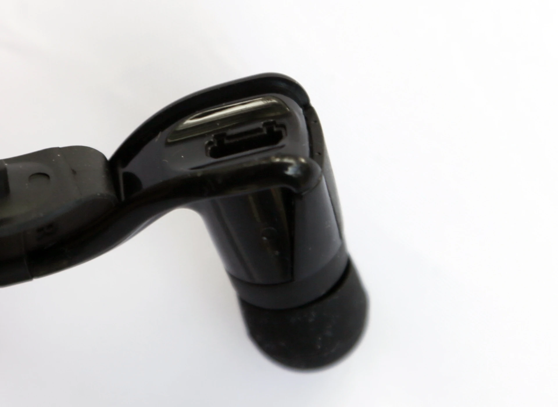 Charging is via a mini USB port concealed at the back of one of the buds (Photo: Gizmag)