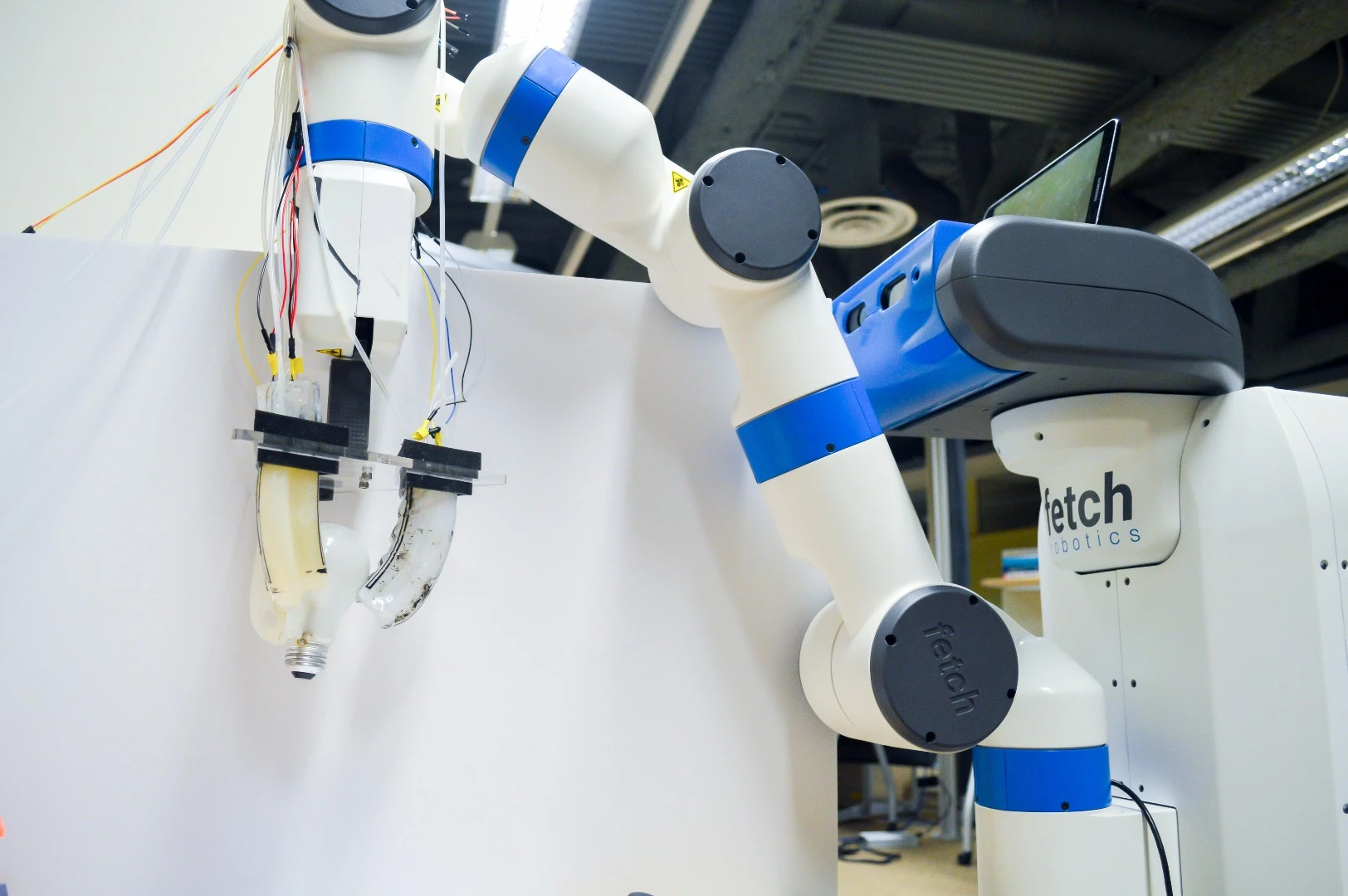 Researchers attached the gripper to the arm of a Fetch Robotics robot