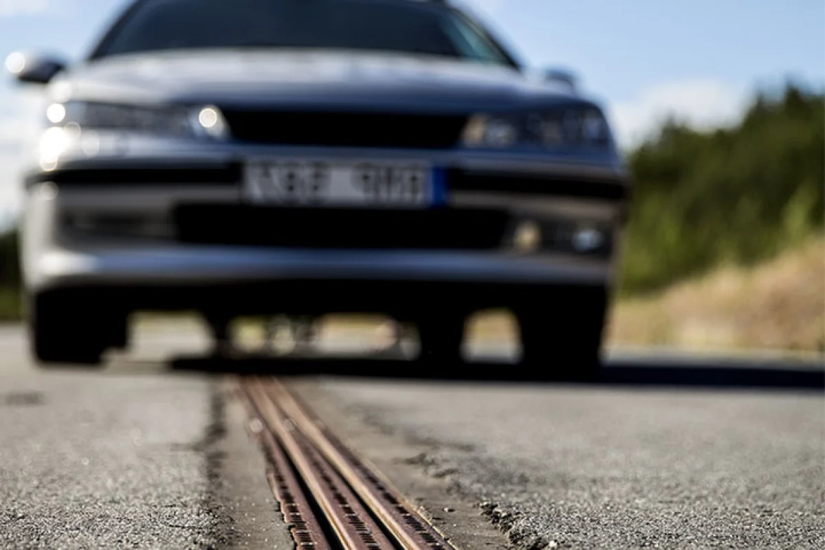 The Swedish project eRoadArlanda powers electric vehicles through a slot car-like track embedded in the road