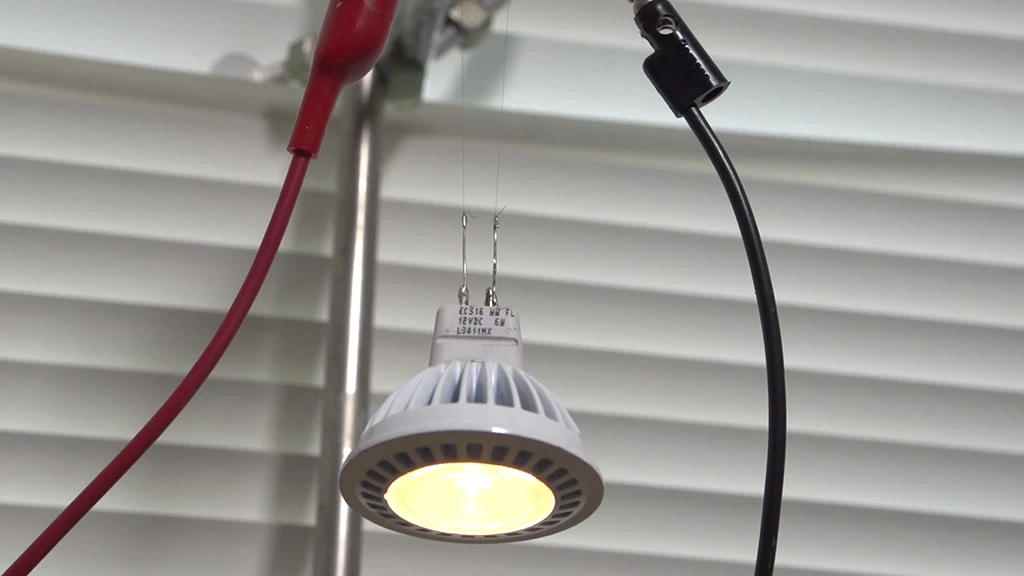 Two strands of the new CNT fiber support and supply current to an LED bulb