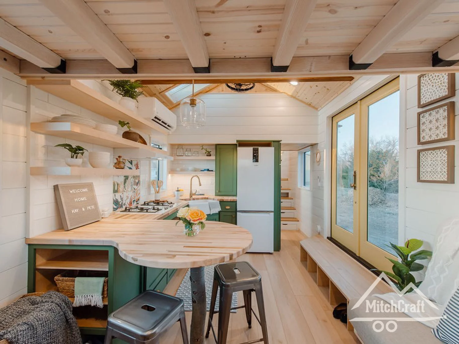 The kitchen features a built-in corner dining bench