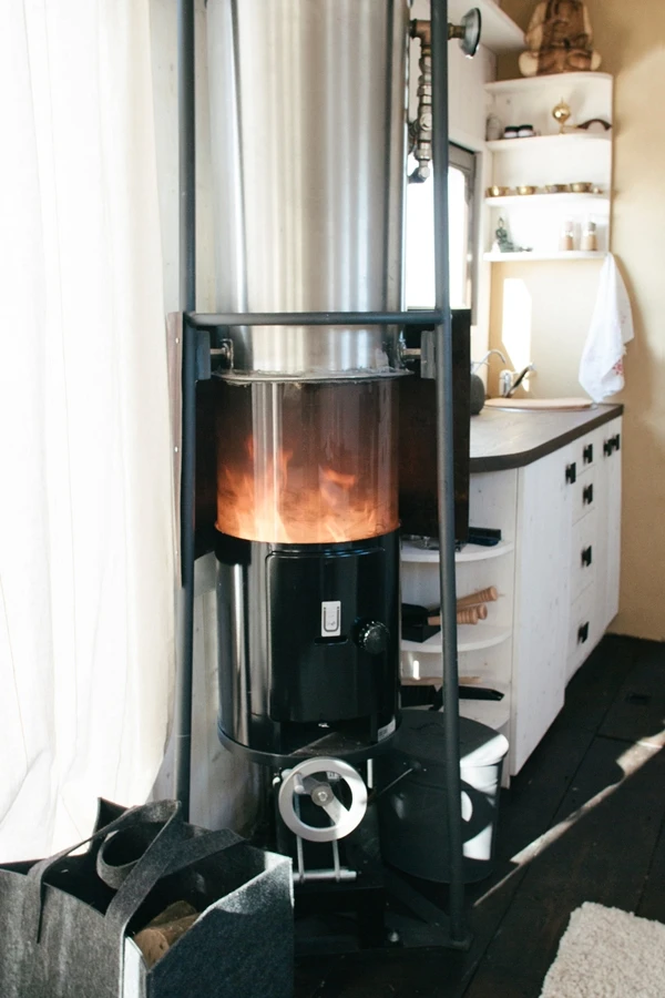 The Wohnwagon heats water using a solar-wood stove