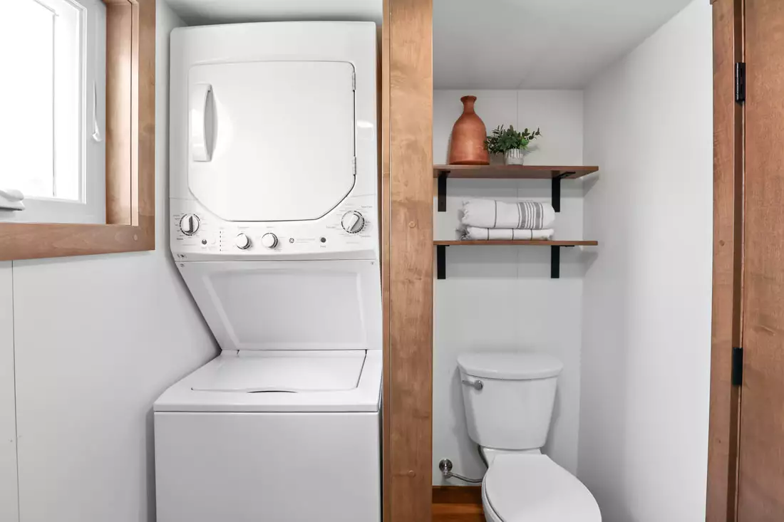 Mi Casita's bathroom includes a standard flushing toilet plus a washer/dryer