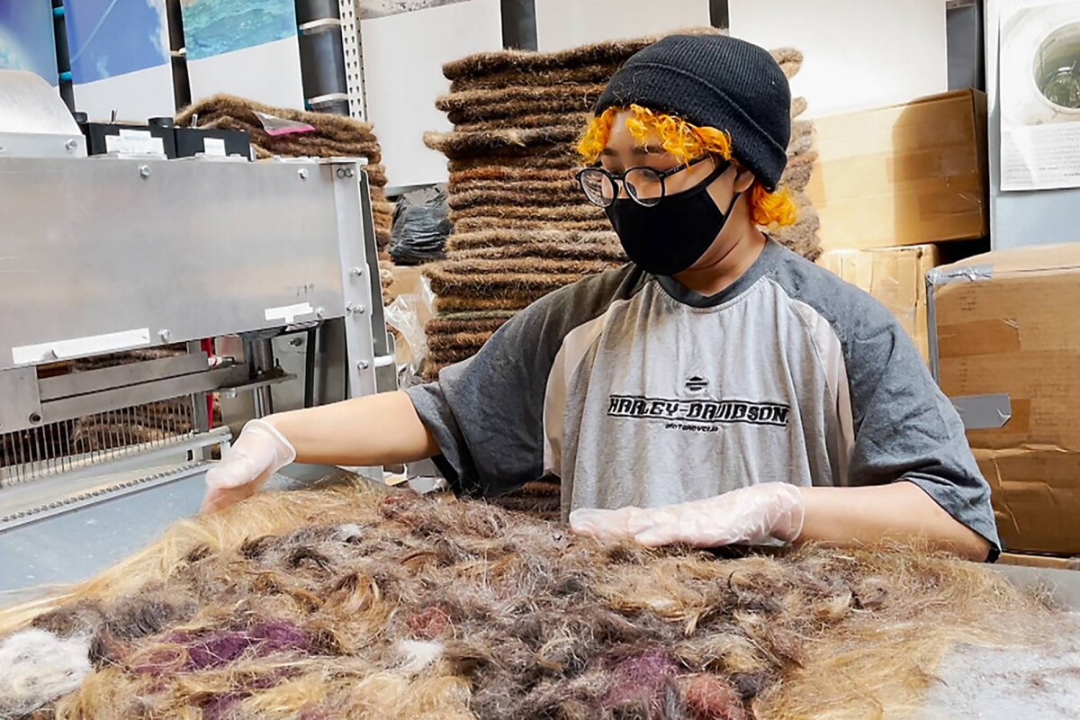 In the process of felting a hair mat. She has gloves on