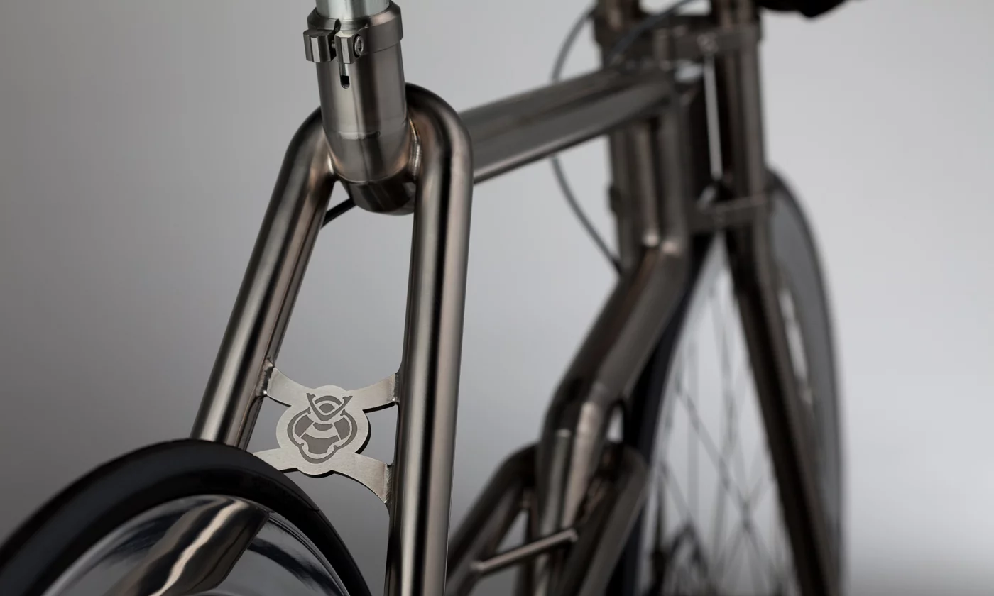 Instead of simply bending the titanium tubes to create curves, those curves are made by incrementally TiG-welding together a series of fan-shaped pieces of titanium