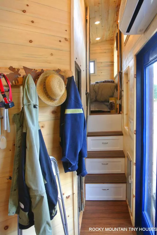 A set of storage-integrated stairs lead to the main bedroom in the Rusted Mountain Roost