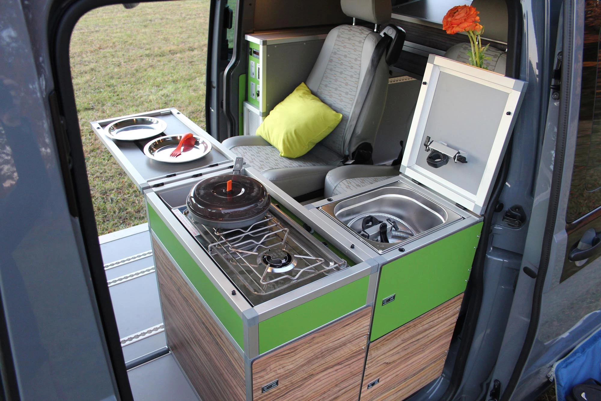 The Terracamper Tecamp swings the kitchen over to the driver side in a compact L layout, making room for a second rear seat/sleeping berth