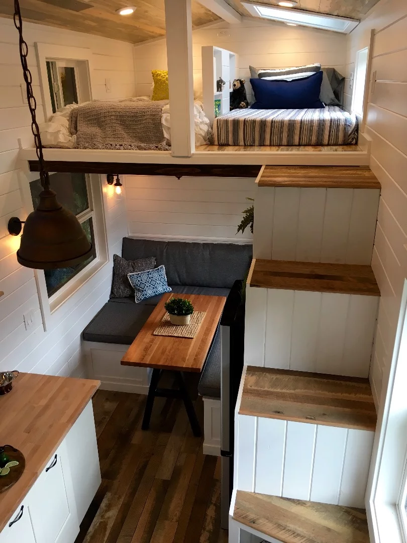 The Rocky Mountain Tiny Home features a double storage staircase that leads to the two sleeping lofts