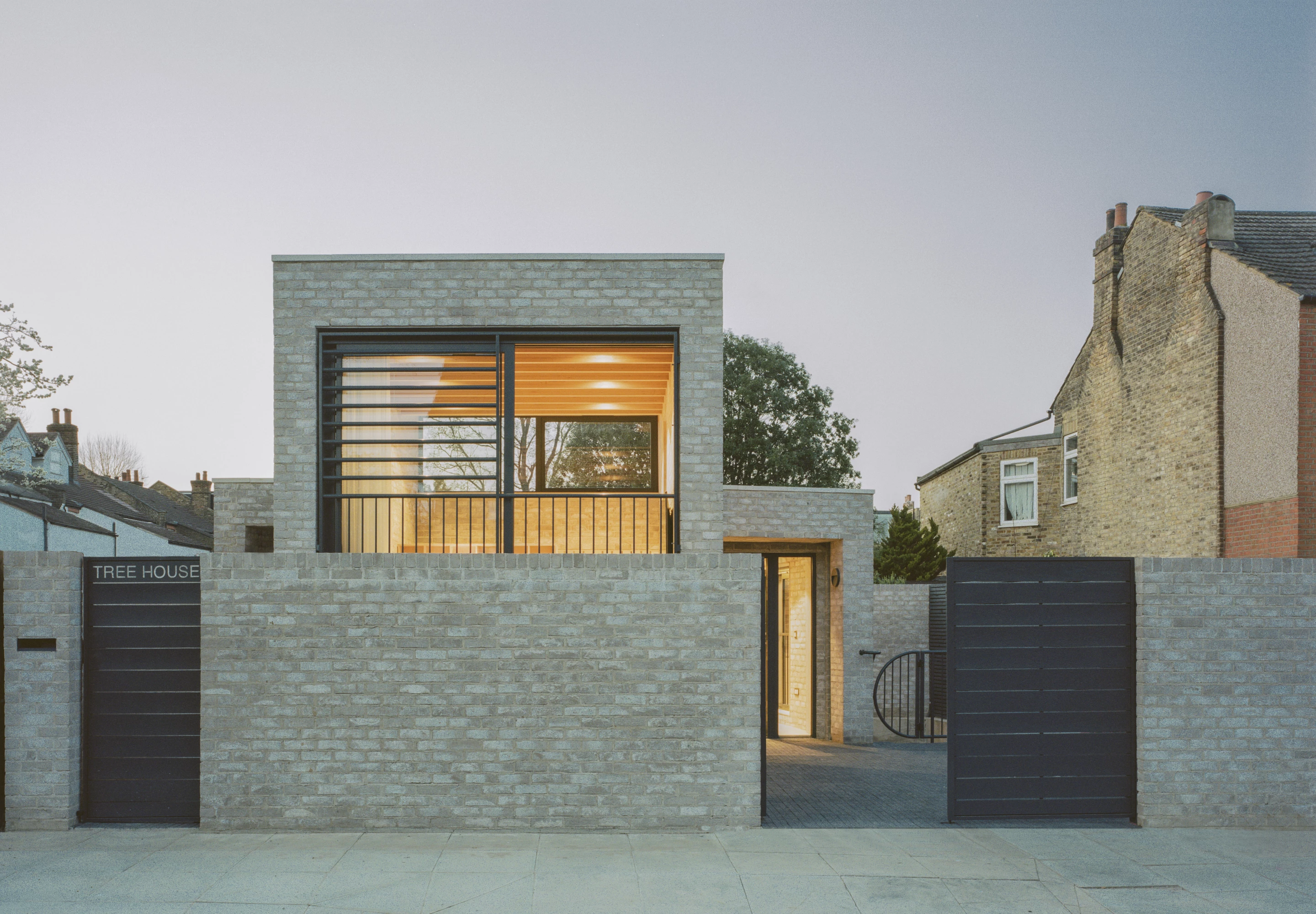 Peeking house was designed by Fletcher Crane Architects and is located in London. It replaces an unsightly garage and was built to a low budget on a constrained site