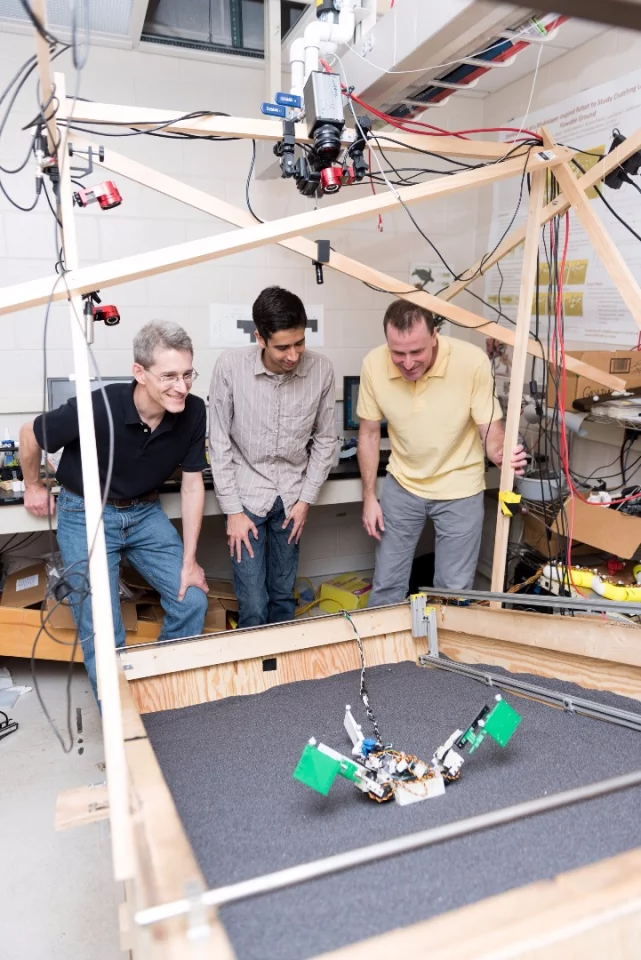 Researchers (l-r) Richard Blob, Ben McInroe and Dan Goldman watch MuddyBot climb