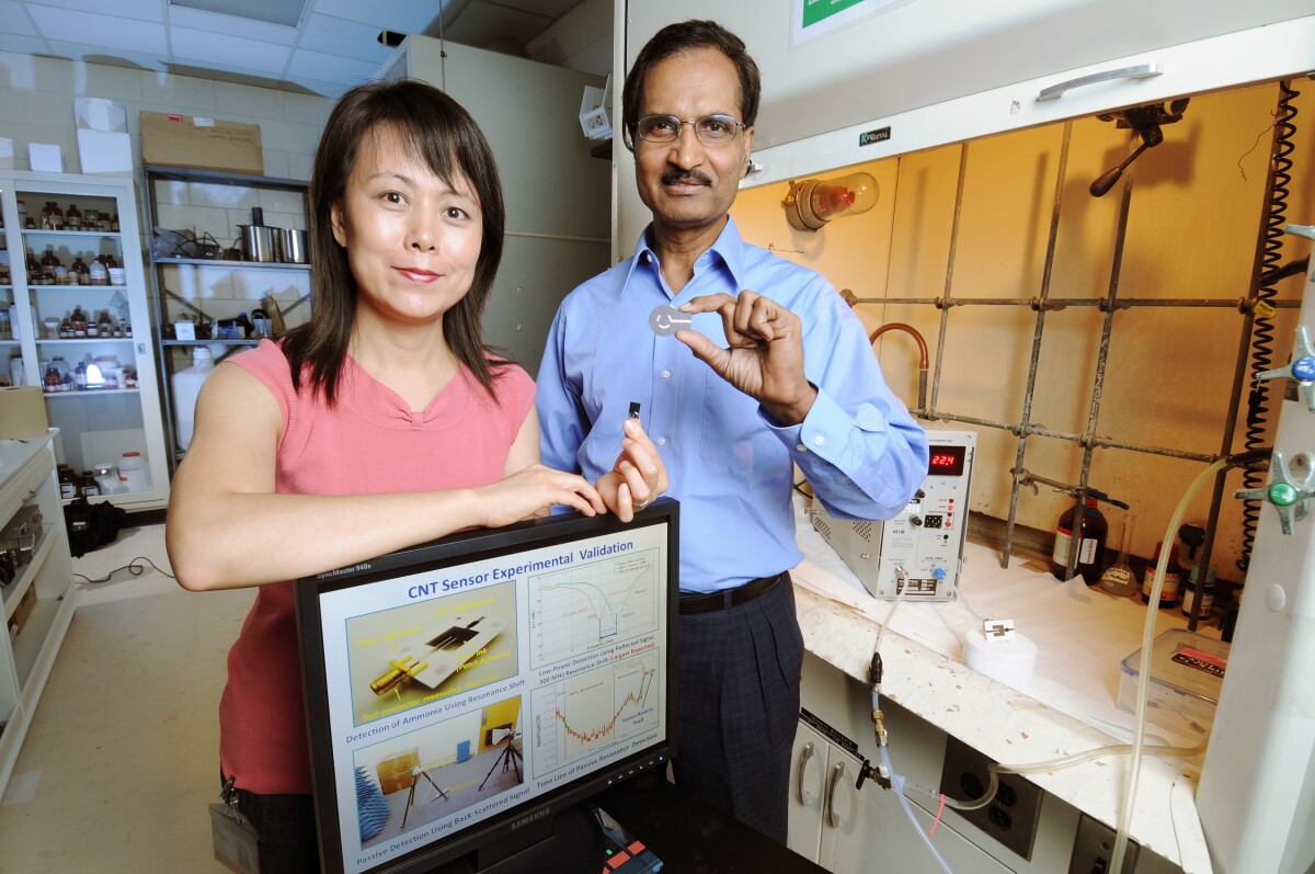 Xiaojuan (Judy) Song and Krishna Naishadham and display two prototype wireless explosives detector devices (Photo: Greg Meek, Georgia Tech)