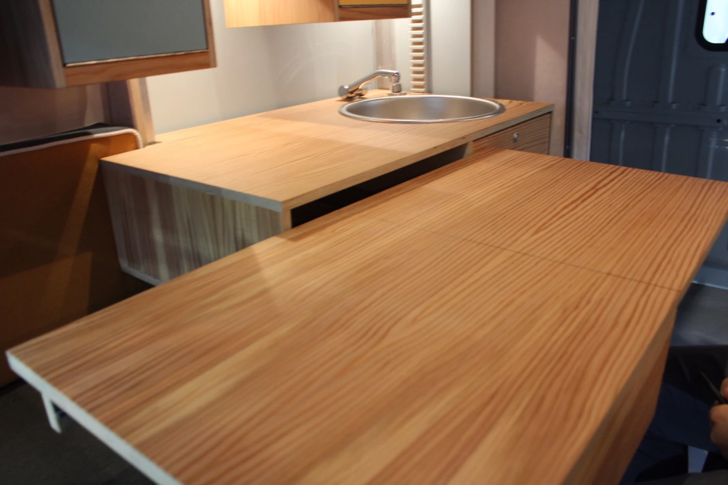 The PlugVan's fold-out table works with the seating bench to create a dining area