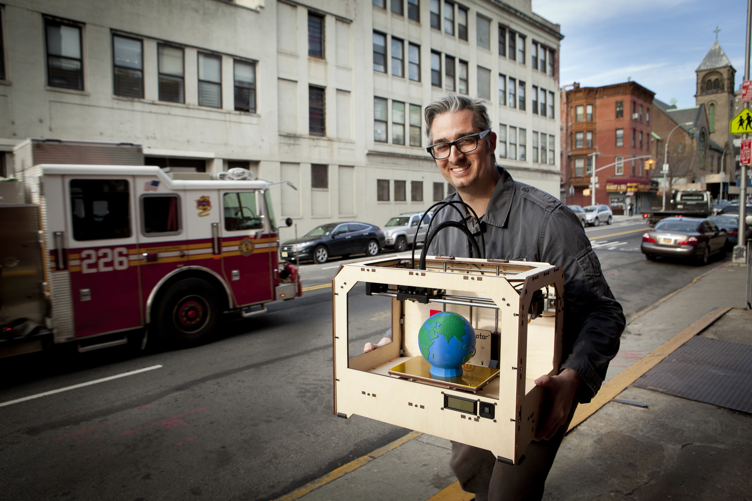 MakerBot's Bre Petis carries the new Replicator 3D printer to CES 2012