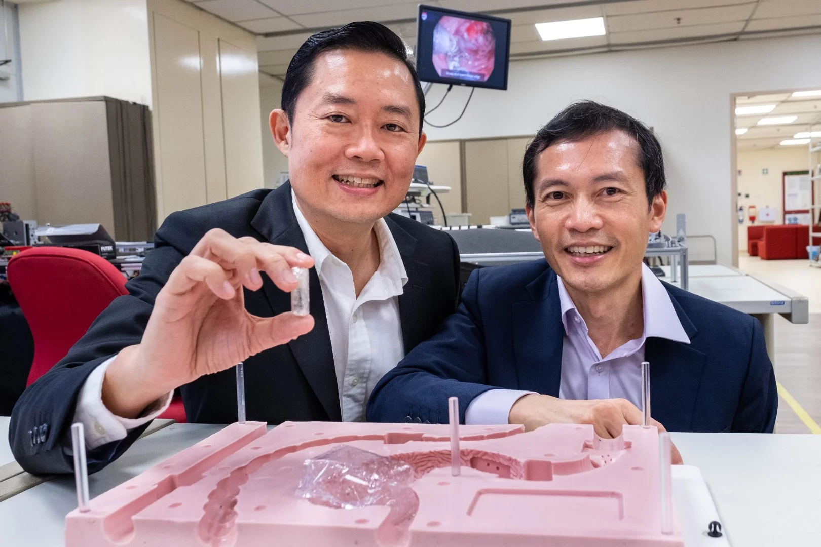 Prof. Louis Phee (left) and Prof. Lawrence Ho, with the prototype EndoPil