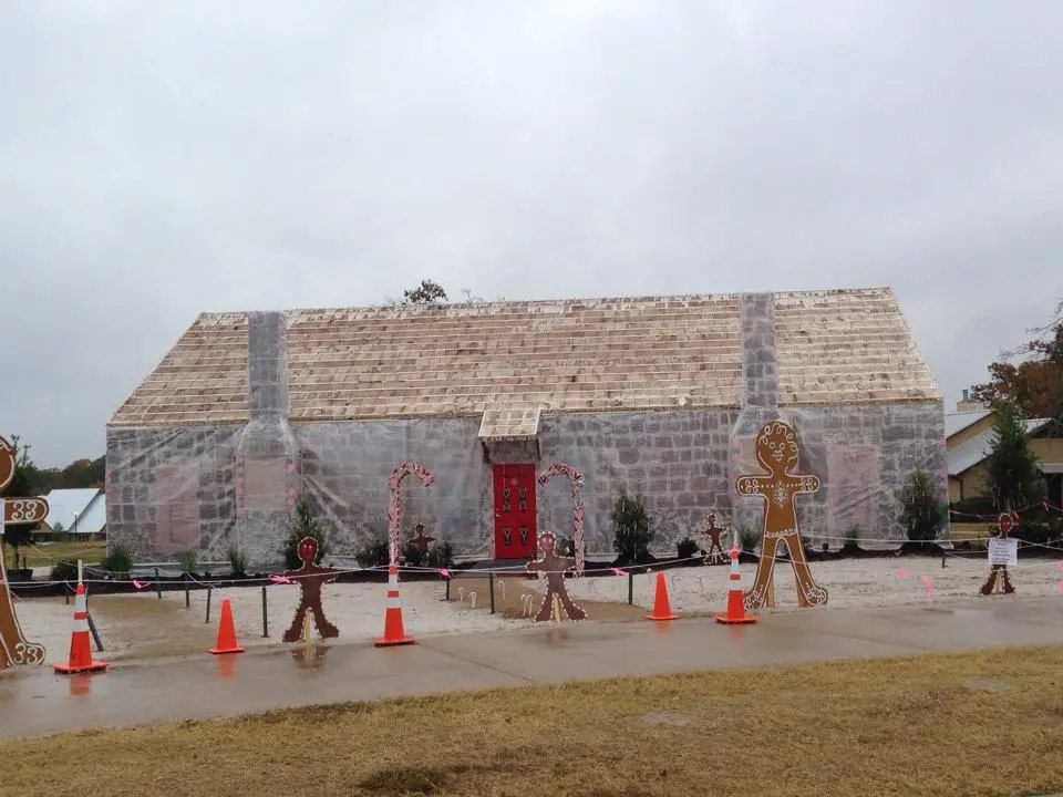 The gingerbread house gets protected from the rain