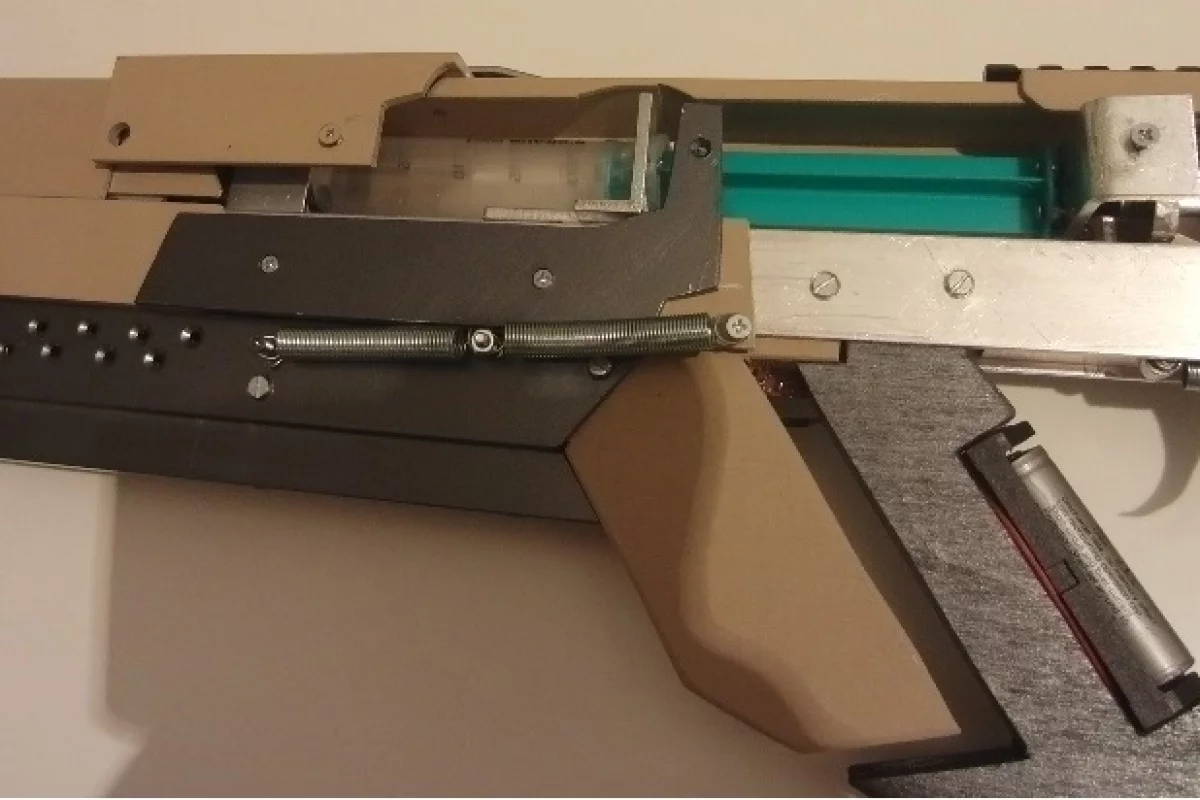 A close-up view of the syringe (green), which forces air down the barrel