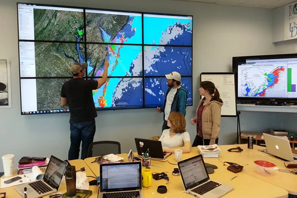 Prof. Matthew Oliver (left) and students plan the OTIS mission