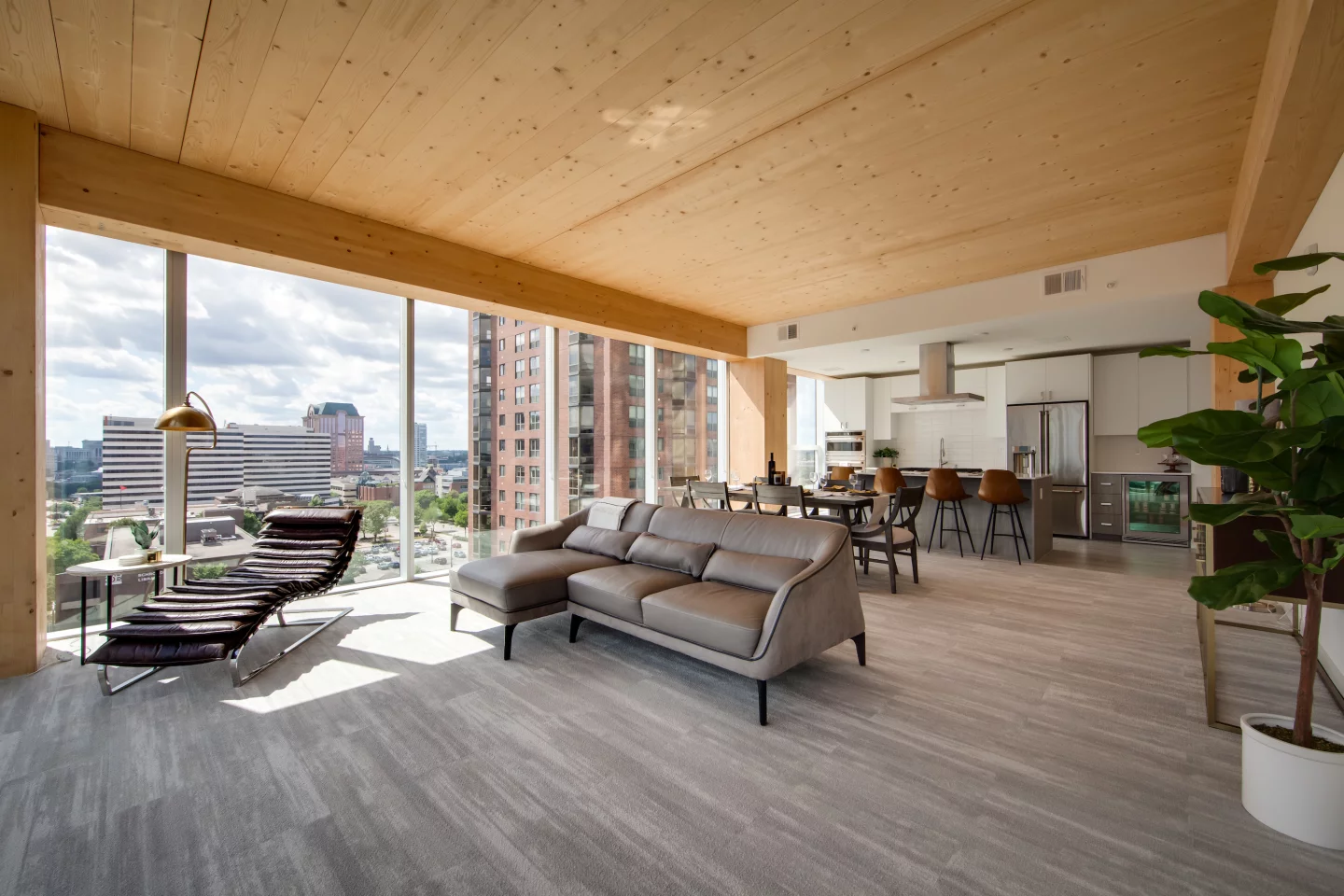 The Ascent's apartments feature generous glazing and the interior decor leans into the natural beauty of the wood