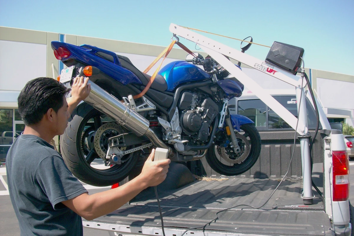 Spitzlift's miniature cranes make lifting a bike into a truck easy