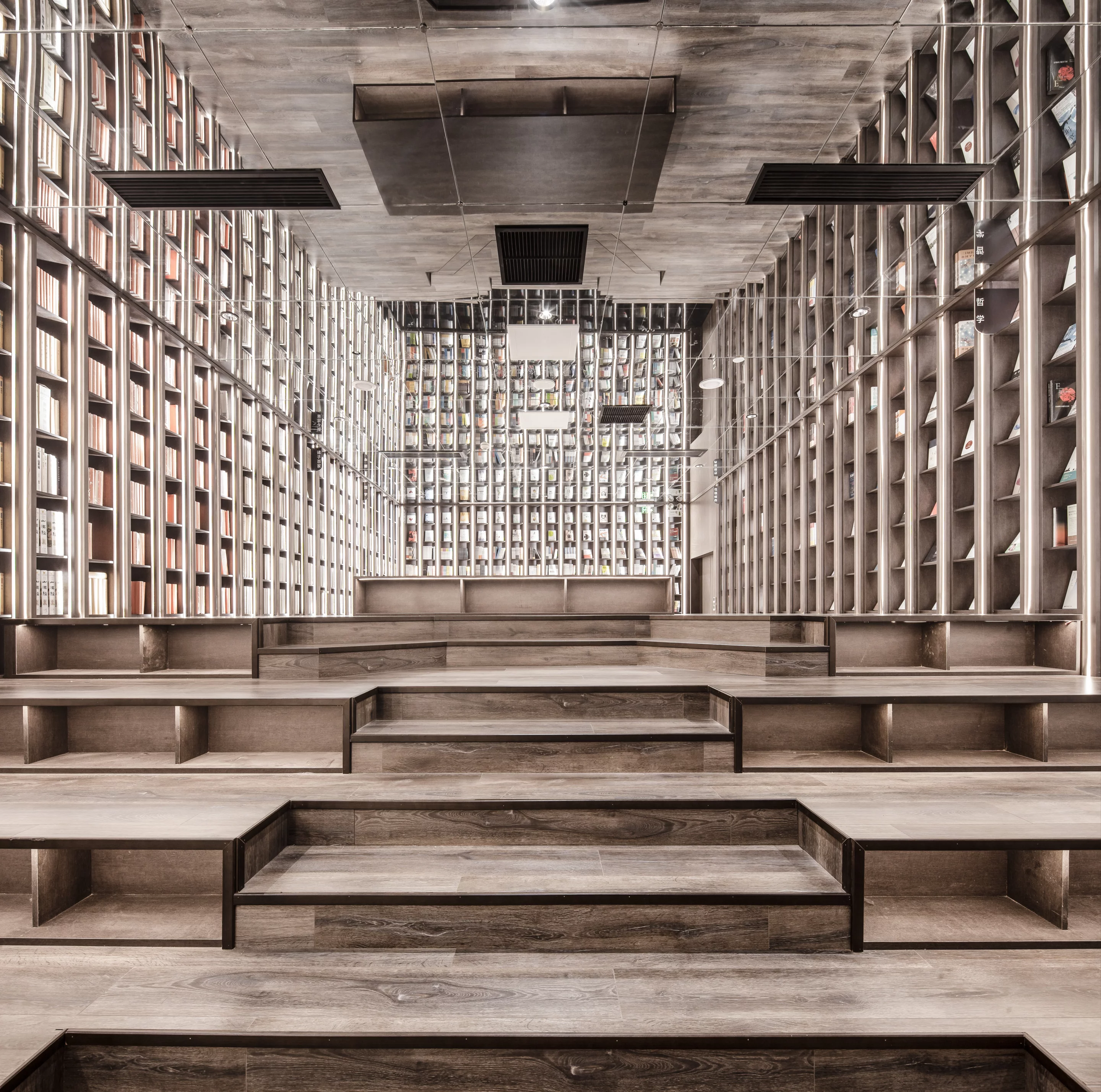 Walnut-colored stairs lead up to these bookshelves inside the surreal Zhongshuge bookstore in Ningbo, China