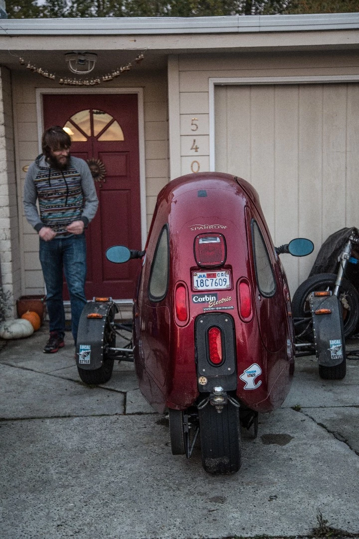 Luke Workman with his Corbin Sparrow. That's Death Bike under the tarp.