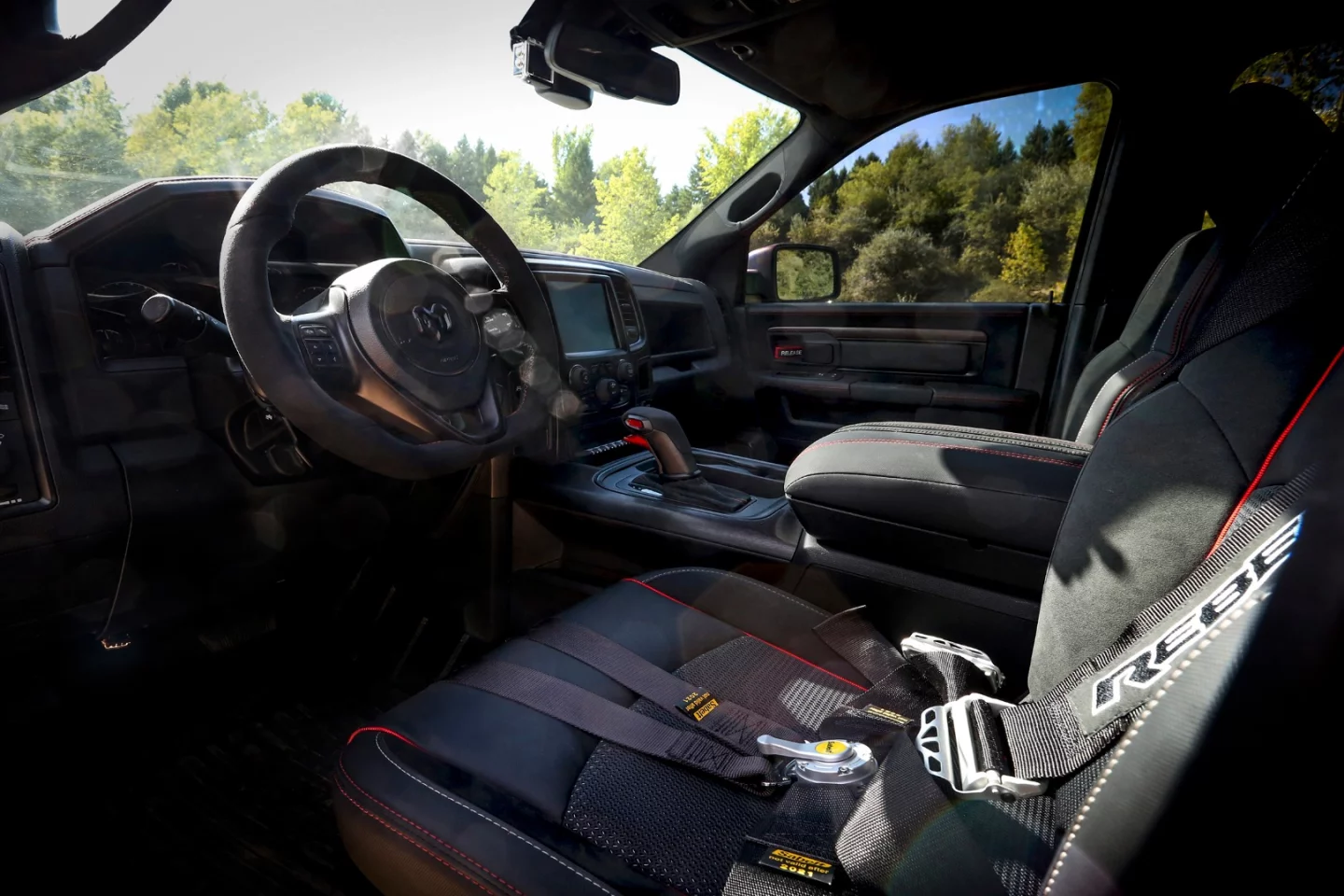 The Ram Rebel TRX interior includes six-point harnesses and suede trim