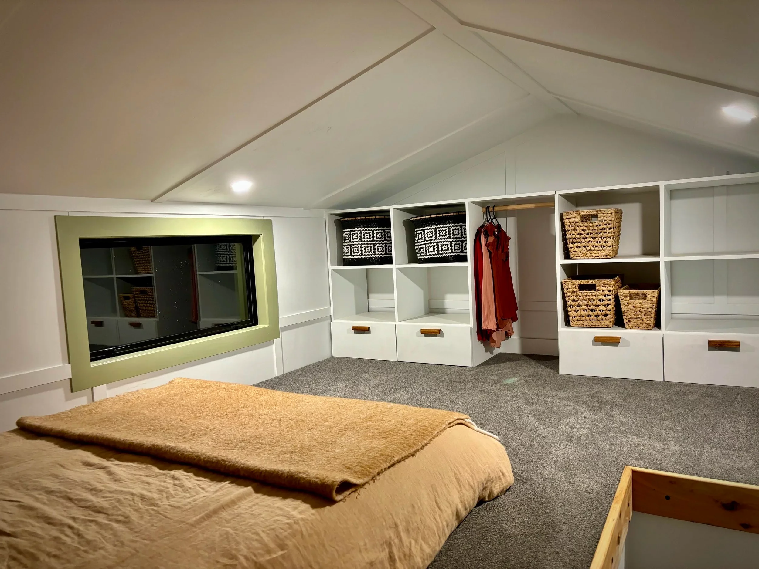 The Redwood's loft bedroom features a double bed and some additional storage space