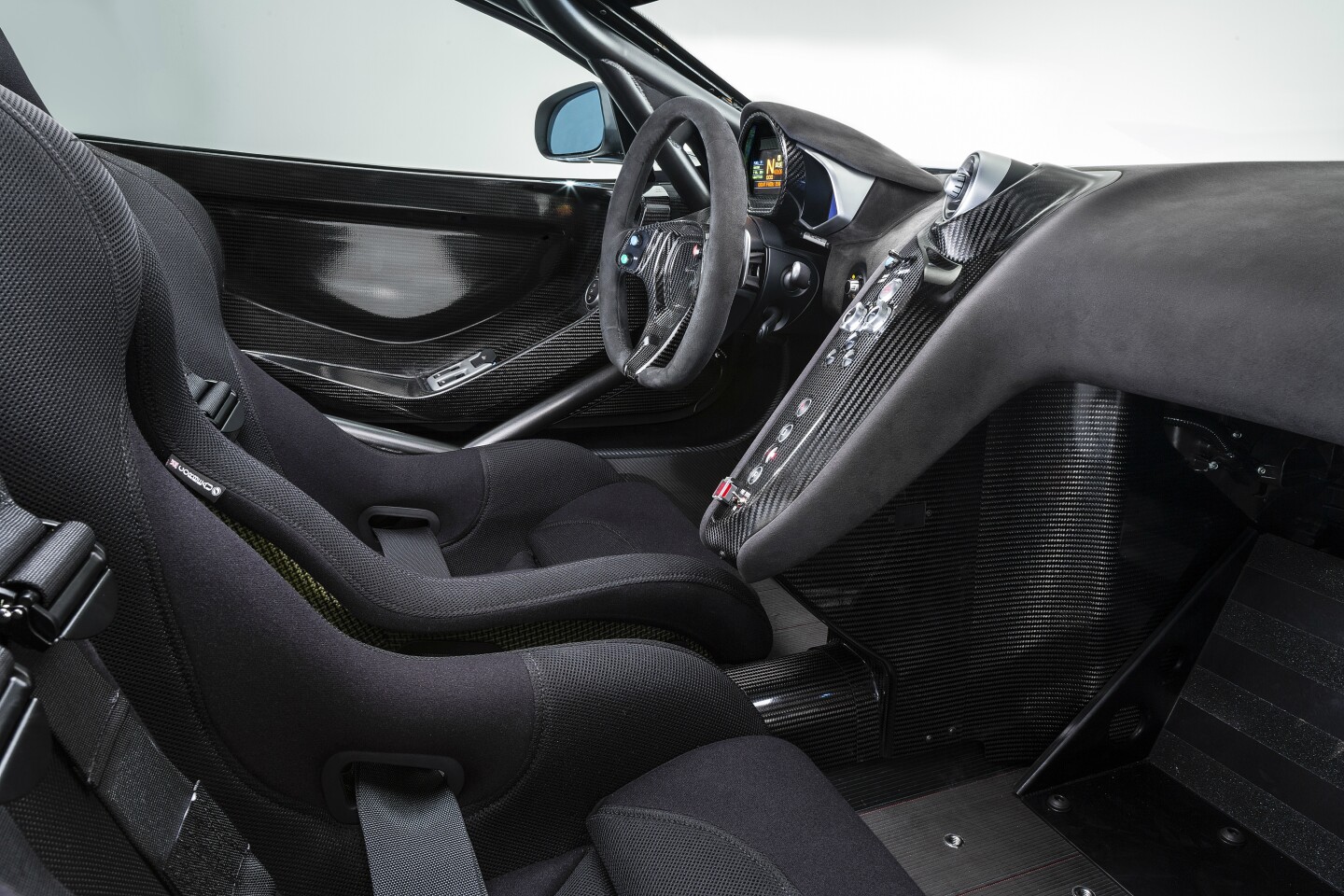 To enhance safety an FIA approved rollcage and carbon fiber HANS-approved racing seats, featuring six-point racing harness for the driver have been built into the snug new cockpit