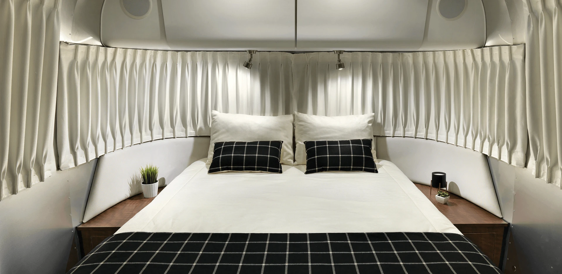 Made to sleep up to six people, the Airstream Globetrotter's bedroom features an adaptive foam mattress surrounding by curvy, low-profile panoramic windows