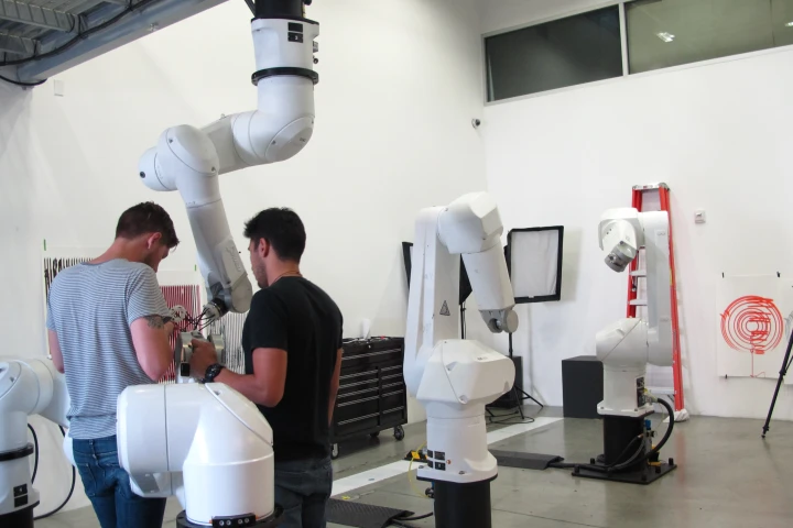 Students applying fittings and materials created using the 3D printer to the robotic arms (Photo: Phyllis Richardson)