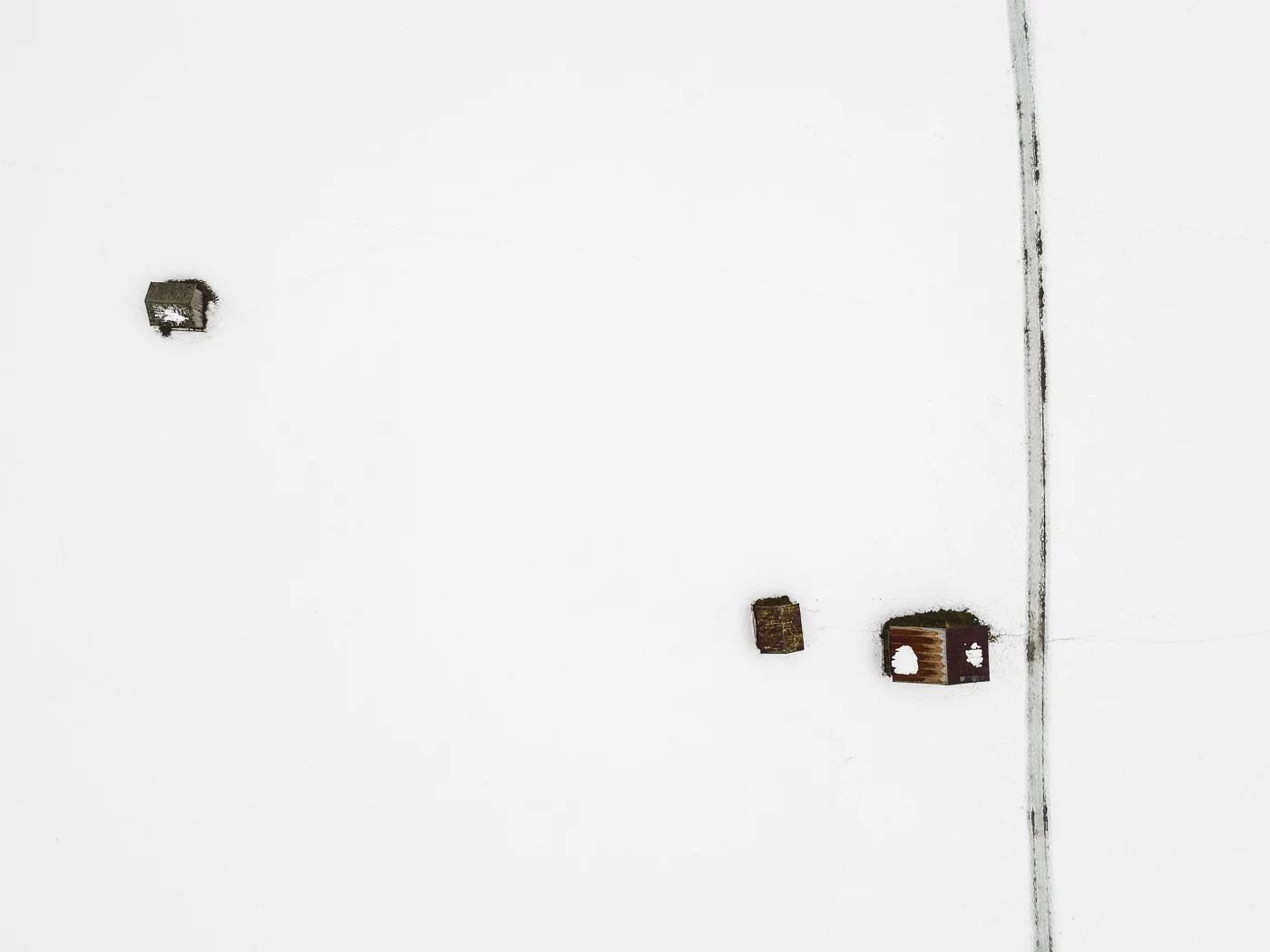 The Farmland Series: A look at farmland during winter in the Allgaeu Alps, a pre-alpine region in Germany. These open landscapes become dusted with white snow leaving only the human farming traces to stand out