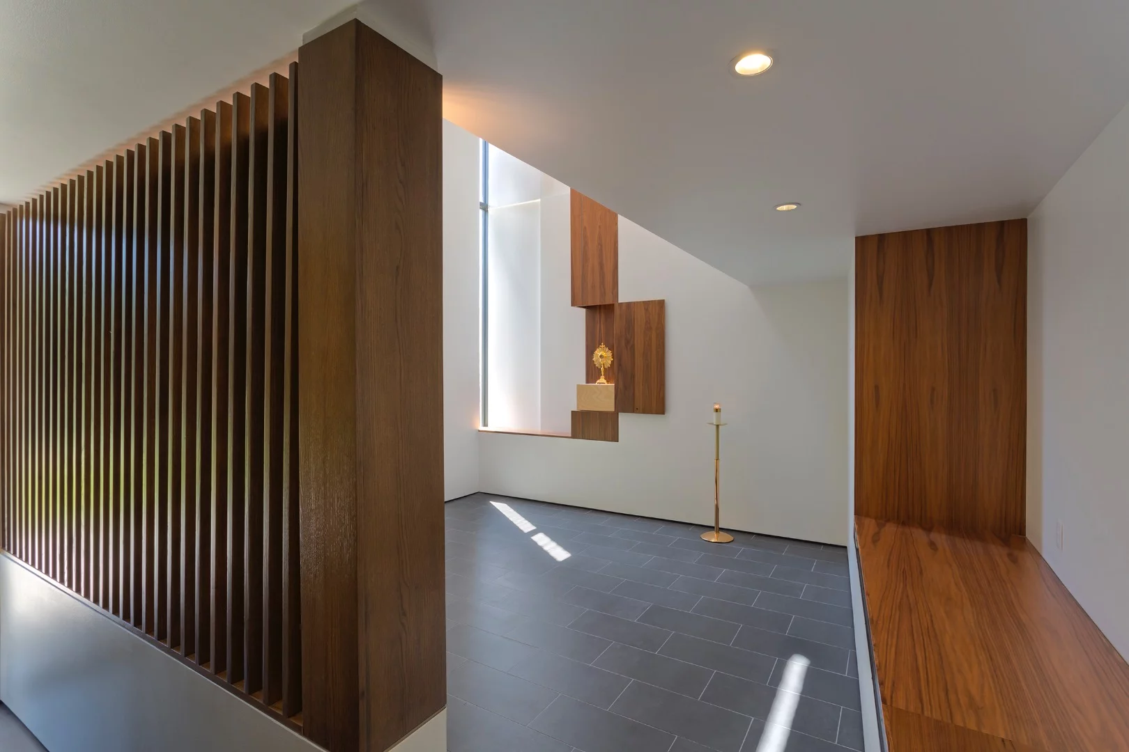 St. Pius Adoration Chapel and Prayer Garden's floor plan shepherds the worshiper through a small vestibule that is separated from the main sanctuary by a slatted wood screen