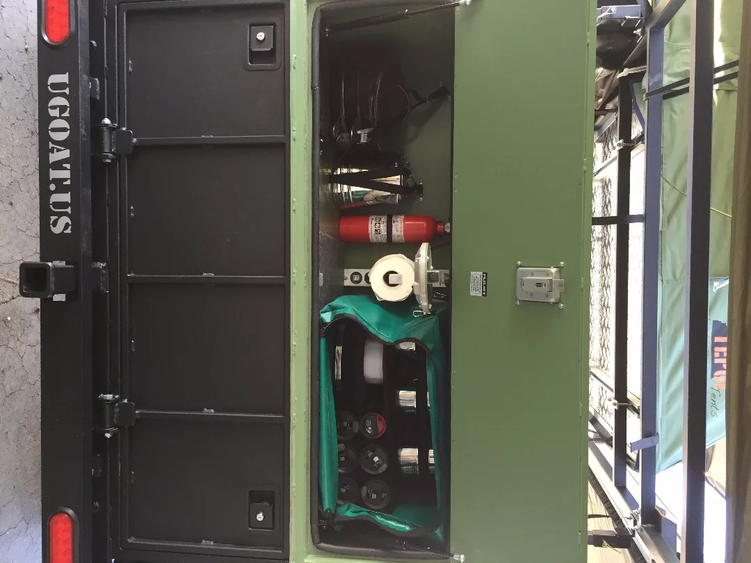 Instead of a more hard-wired kitchen, UGOAT keeps the Scout trailer simple with a gear-stocked cabinet