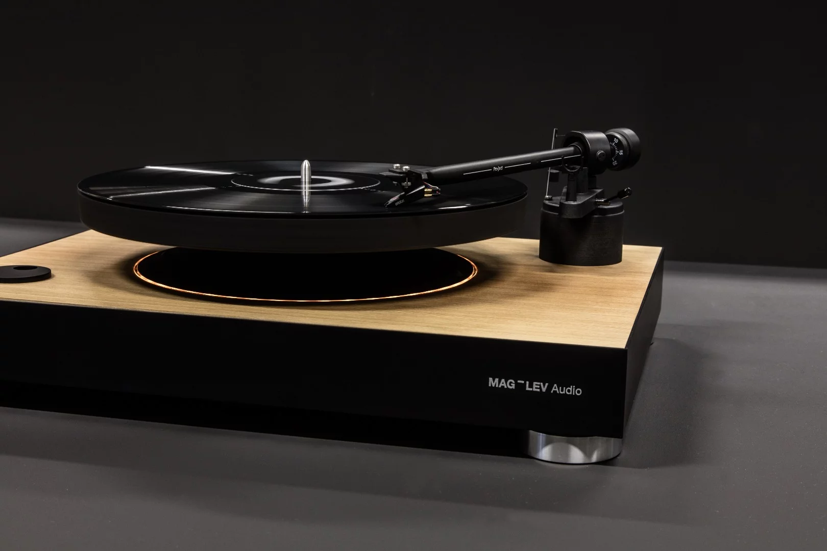 The spin is started by selecting either 33.3 and 45 RPM on the dial to the left, when the Mag-Lev turntable platter enters a digitally-controlled spin 37 mm (1.45 in) above the base