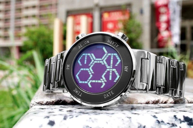 The watch casing is available in black or silver, while the face itself is offered in blue, purple and green