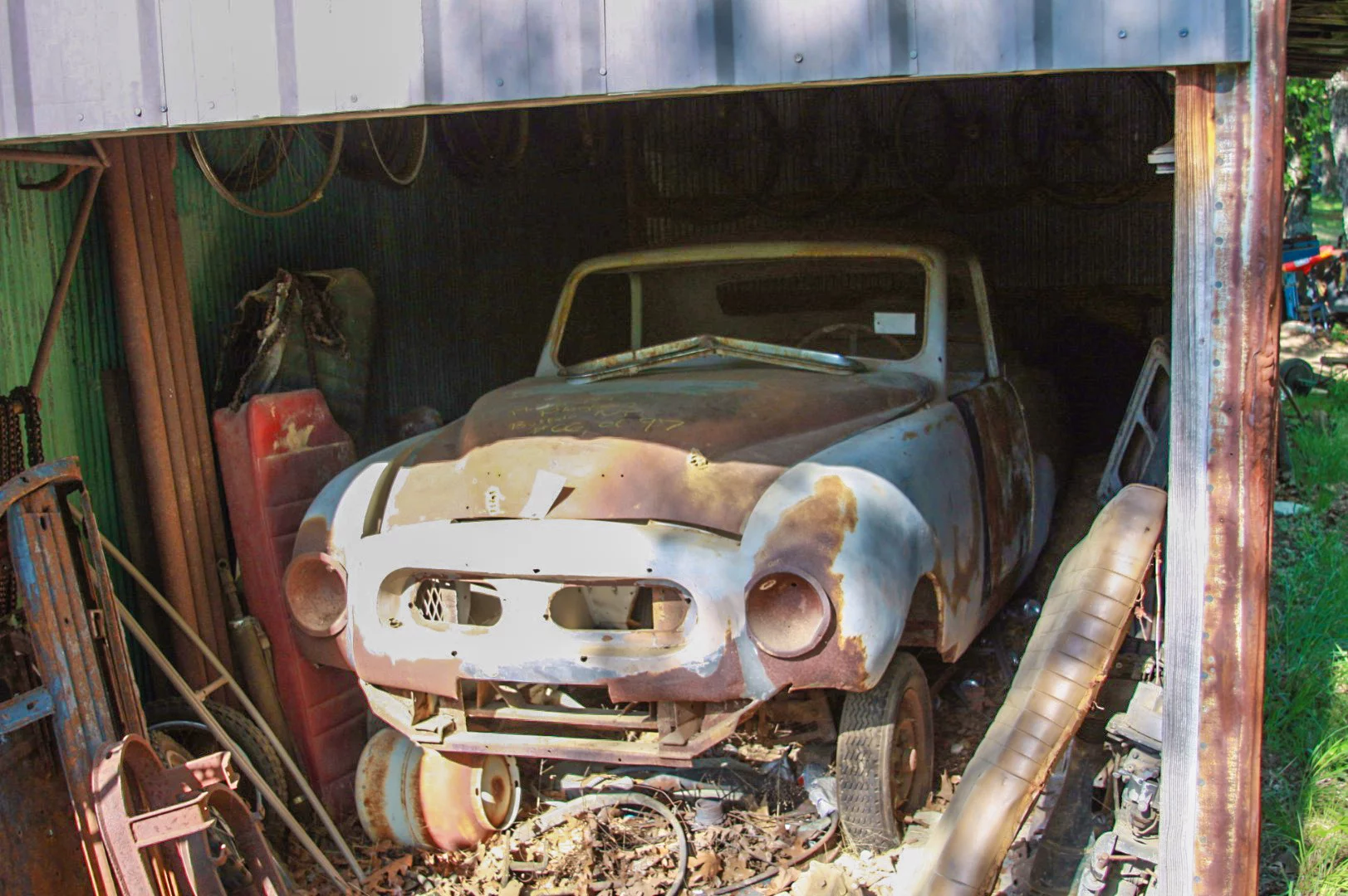 An orphan car shared space with farm implements and even an old sled