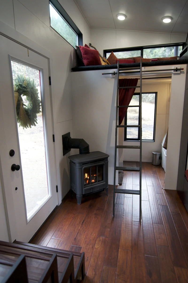 A stepladder leads up to the second raised loft area