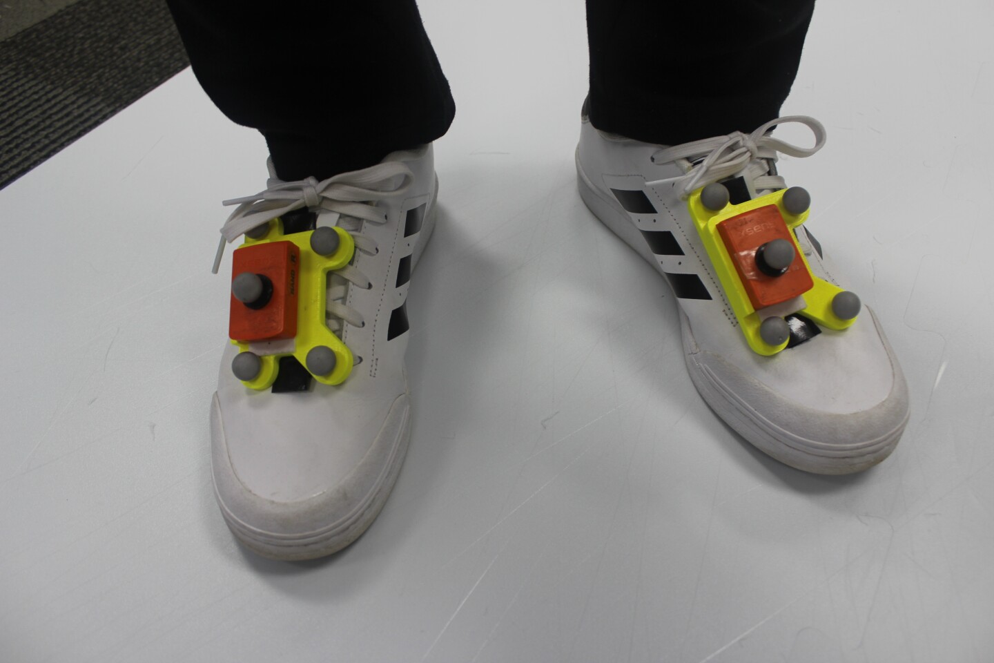 The system's combined retroreflective markers and IMUs