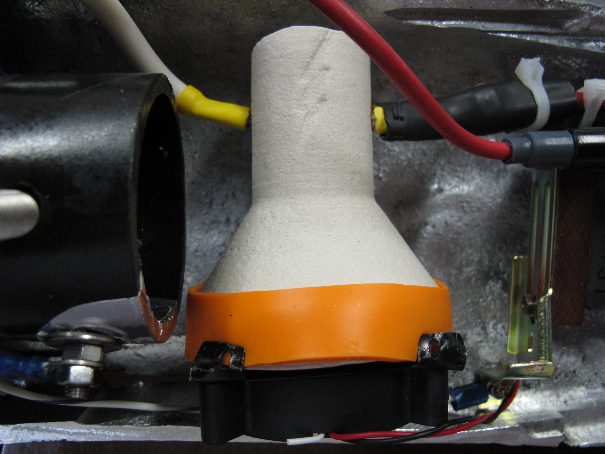 Ceramic tungsten high voltage switch sitting on top of a CPU fan, which is said to draw hot ions out of the switch to help create bigger, rapid lightning bolts