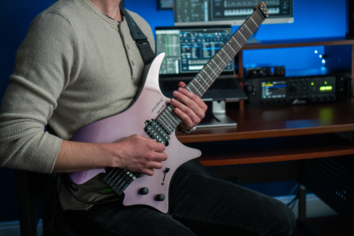 Divisive headless ergo guitar gains expressive MIDI power