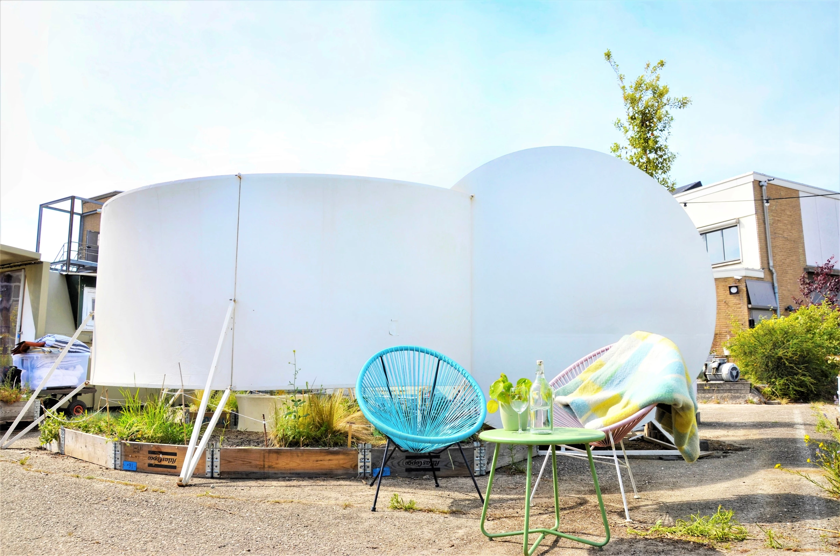 Second Skin features a double bed inside and some seating outside, while a garden is installed underneath the raised shelter
