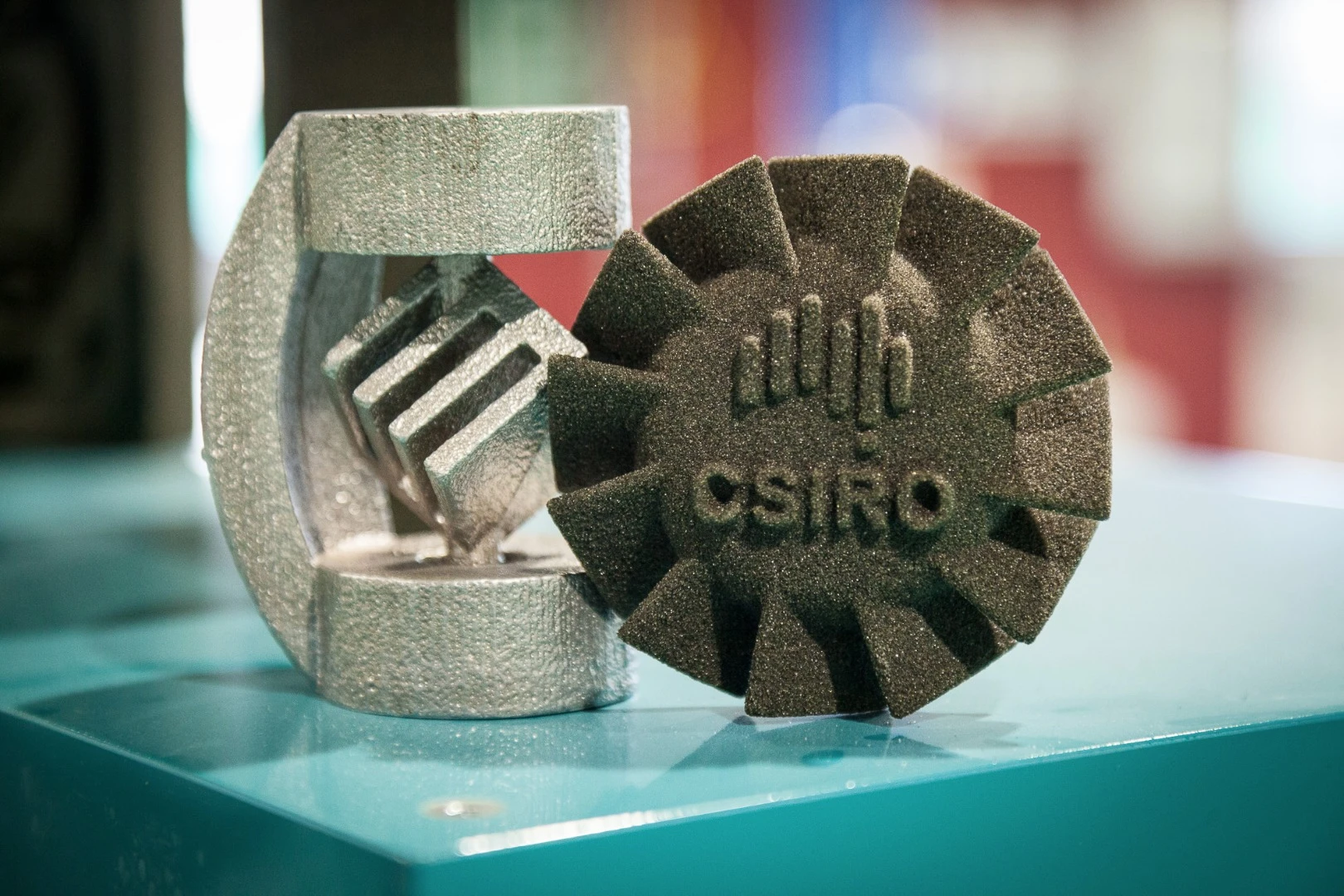 Left: a sample part cast in a sand-printed mold. Right: a sand-printed demo disc