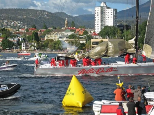 WILD OATS XI crossing the finish line and breaking the Rolex Sydney Hobart Yacht Race record Photo: Daniel Forster