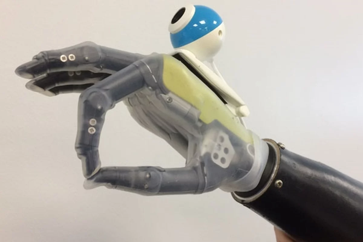 The prototype hand uses an off-the-shelf digital camera to help reach for and grasp objects