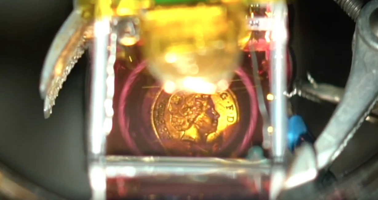 After current is applied. Note the coin's reflection appearing