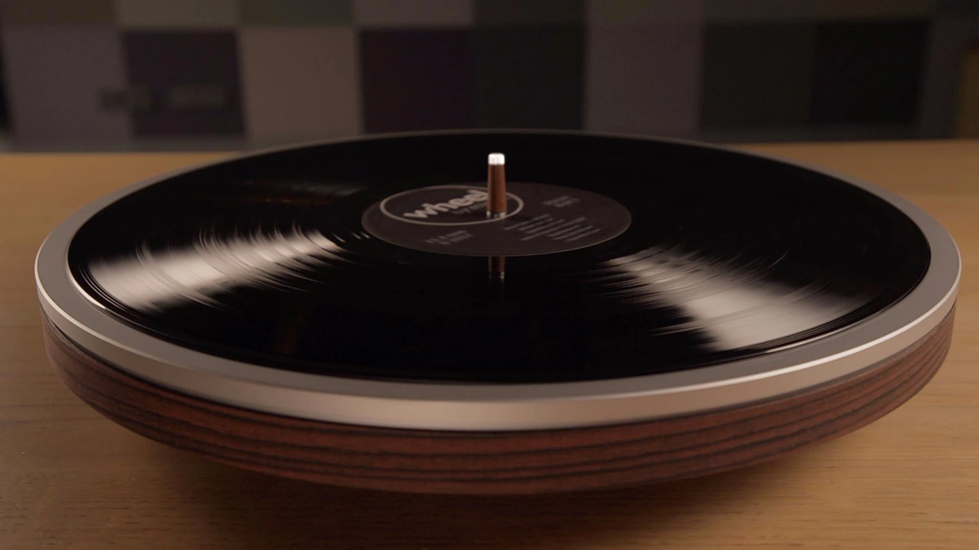 The underside of the record is played using a tonearm and cartridge mounted within the body of the Wheel turntable