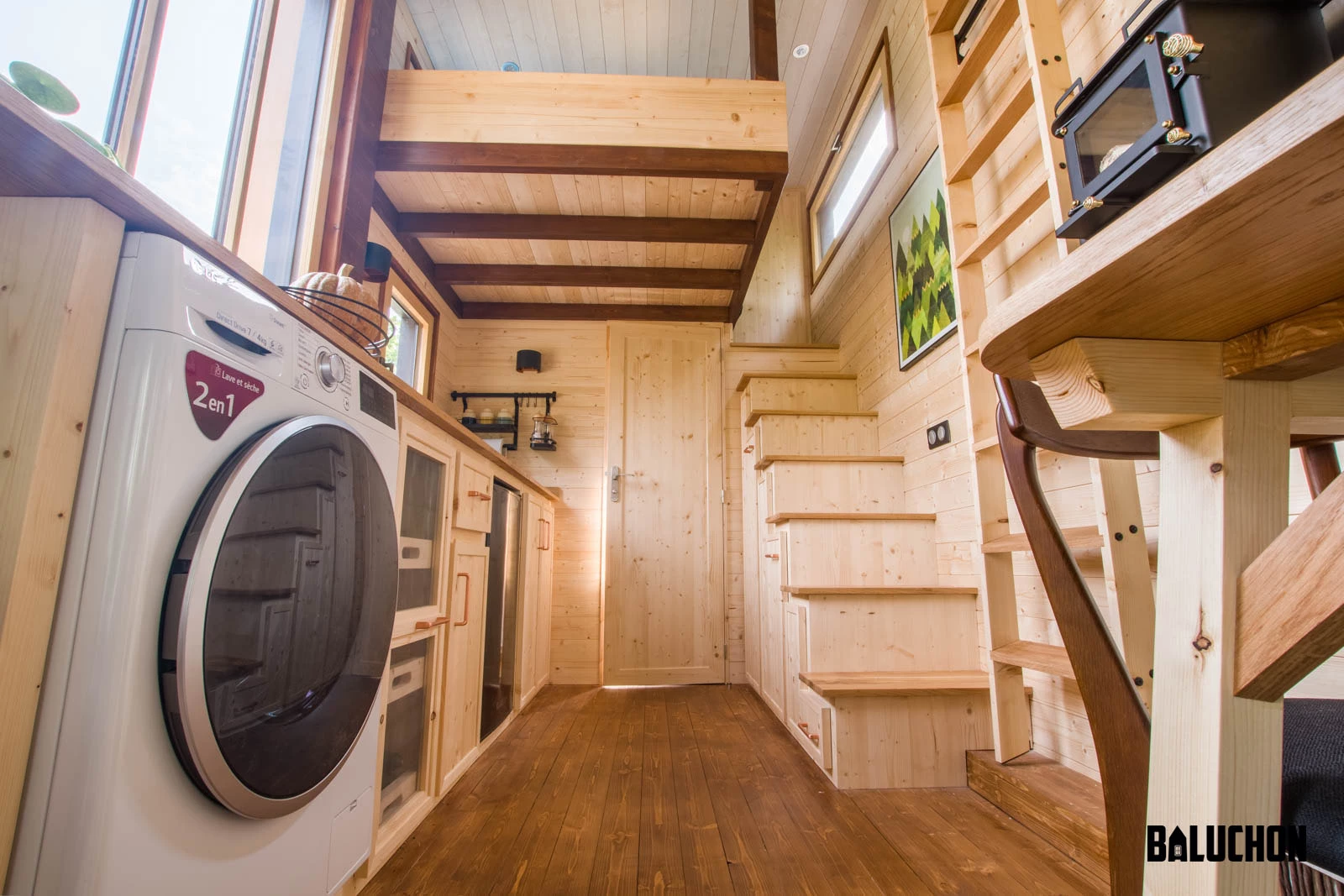 The Astrild Tiny House's kitchen includes a washer/dryer