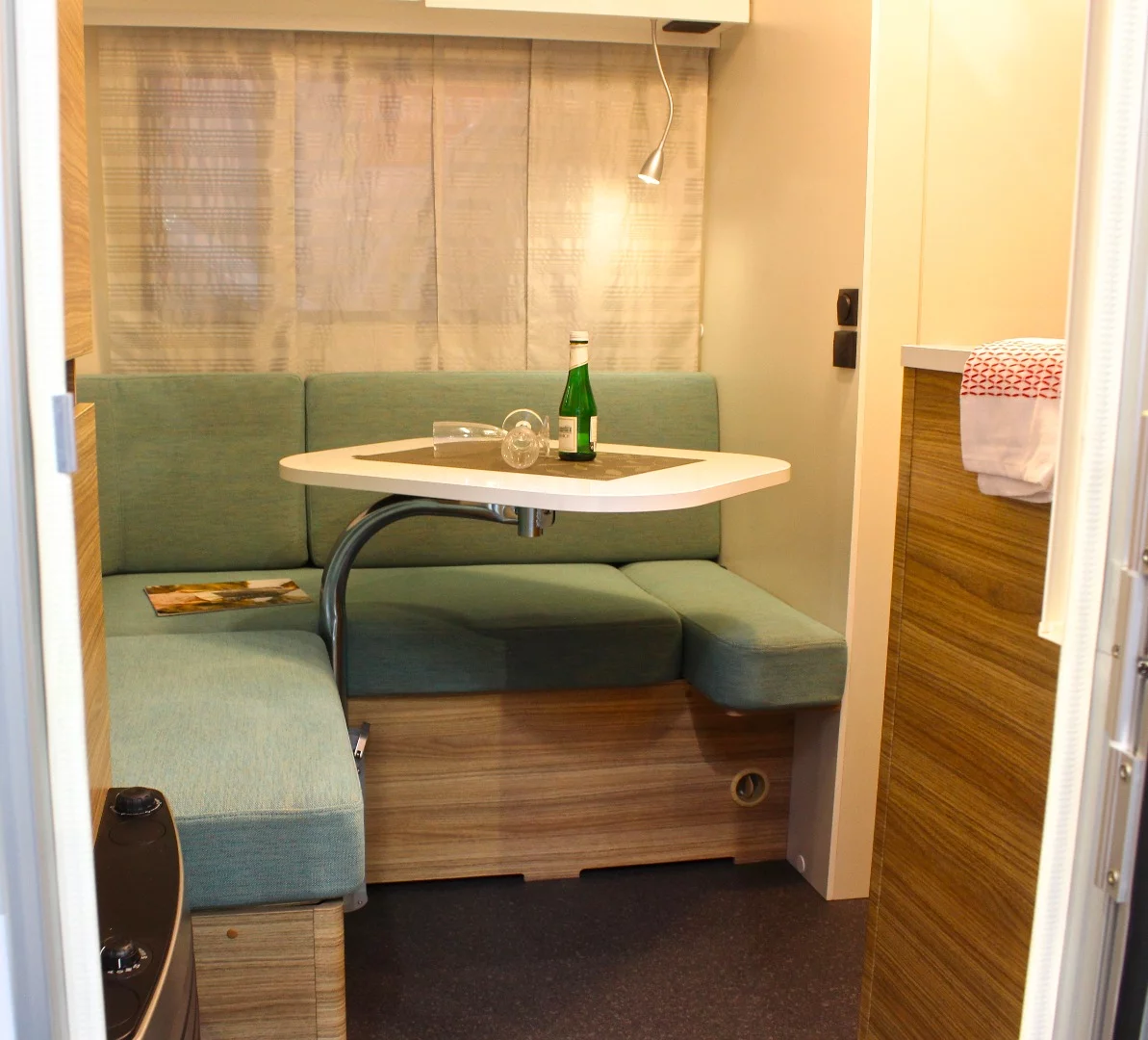 Inside, the Adria Action 391 PD features a corner dinette with adjustable table