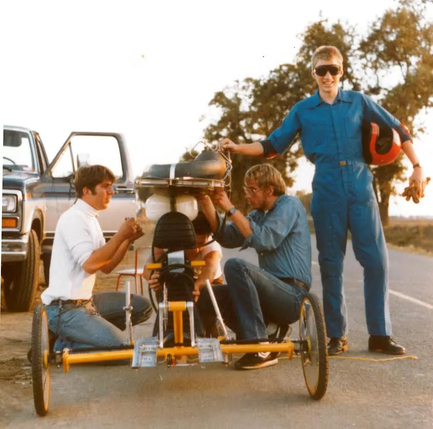 Dezso's brother Tom helps make final adjustments to a valveless pulse jet strapped atop his recumbent trike